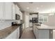 View of the kitchen featuring an island and stainless appliances overlooking the living room at 4050 W Coles Rd, Laveen, AZ 85339