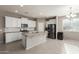 Bright kitchen featuring white cabinets, an island with granite countertops and stainless steel appliances at 4050 W Coles Rd, Laveen, AZ 85339