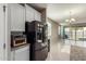 Open-concept kitchen view with stainless steel refrigerator and view into the living room at 4050 W Coles Rd, Laveen, AZ 85339