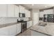 Modern kitchen showcasing white cabinets, granite counters, and stainless steel appliances at 4050 W Coles Rd, Laveen, AZ 85339