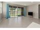 Open living room with tile flooring, a large glass slider with backyard access and neutral paint at 4050 W Coles Rd, Laveen, AZ 85339