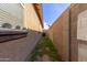 Side yard with dirt, grass, and block wall fence at 4050 W Coles Rd, Laveen, AZ 85339