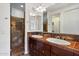 Elegant bathroom with a double sink vanity, a tile backsplash, and a walk-in shower with decorative accents at 4411 N 24Th Way, Phoenix, AZ 85016