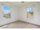 Light-filled bedroom with dual windows offering views of the neighborhood, complete with neutral carpeting at 4411 N 24Th Way, Phoenix, AZ 85016