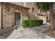 Elegant stone entryway featuring a decorative metal door and manicured boxwood hedges at 4411 N 24Th Way, Phoenix, AZ 85016