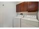 Functional laundry room equipped with a washer, dryer, and overhead cabinets for ample storage space at 4411 N 24Th Way, Phoenix, AZ 85016