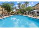 Community pool featuring clear blue water surrounded by lounge chairs and covered cabanas at 4411 N 24Th Way, Phoenix, AZ 85016