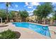 Inviting community pool with a baja step entry and lounge seating for resident relaxation at 4411 N 24Th Way, Phoenix, AZ 85016