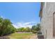 A well maintained backyard is complete with green grass, mature trees, and HVAC components at 4490 S Rio Dr, Chandler, AZ 85249