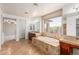 Bright bathroom featuring dual vanities, a large soaking tub, and tile flooring at 4490 S Rio Dr, Chandler, AZ 85249