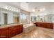 Bright bathroom boasts dual vanities, a large soaking tub, and travertine tile at 4490 S Rio Dr, Chandler, AZ 85249
