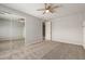 Spacious bedroom featuring neutral carpet, ceiling fan and mirrored closet at 4490 S Rio Dr, Chandler, AZ 85249