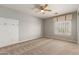 Bedroom with a ceiling fan and a large window at 4490 S Rio Dr, Chandler, AZ 85249