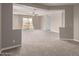Open bonus room with neutral carpet, gray walls, a balcony, and a ceiling fan at 4490 S Rio Dr, Chandler, AZ 85249