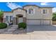 Charming two-story home featuring a three car garage, stone accents, and lovely landscaping at 4490 S Rio Dr, Chandler, AZ 85249