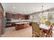 Open kitchen featuring dark cabinets, white countertops, stainless steel appliances, and dining area at 4490 S Rio Dr, Chandler, AZ 85249