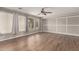 Bright living room featuring hardwood floors, modern gray walls, and abundant natural light at 4490 S Rio Dr, Chandler, AZ 85249
