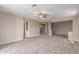Spacious living room featuring neutral tones, carpet, and a ceiling fan at 4490 S Rio Dr, Chandler, AZ 85249