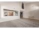 Open living space with neutral carpet, high ceilings, and a decorative chandelier at 4490 S Rio Dr, Chandler, AZ 85249