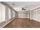 Spacious living room with hardwood floors, gray walls, custom trim work, and large windows at 4490 S Rio Dr, Chandler, AZ 85249