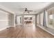 Open concept living room showcasing hardwood floors, adjacent dining area, and ample natural light at 4490 S Rio Dr, Chandler, AZ 85249