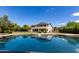 Relax in style with a sparkling pool reflecting the home, a perfect oasis for leisure and entertainment at 4490 S Rio Dr, Chandler, AZ 85249