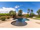 Backyard pool features a rock border, surrounded by a concrete patio, and is surrounded by a block fence at 4490 S Rio Dr, Chandler, AZ 85249