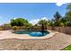 Inviting backyard pool surrounded by desert landscaping and privacy fence with a fun swan float at 4490 S Rio Dr, Chandler, AZ 85249