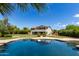An inviting backyard pool offers a refreshing oasis and reflects the home's exterior, promising relaxation at 4490 S Rio Dr, Chandler, AZ 85249