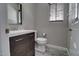 Bathroom with modern vanity, white toilet, gray plank flooring, and window with brown wood blinds at 4777 S Fulton Ranch Blvd # 1024, Chandler, AZ 85248
