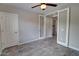 Cozy bedroom with wood-look tile flooring and a view through glass paneled doors at 4777 S Fulton Ranch Blvd # 1024, Chandler, AZ 85248