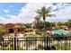 Community pool featuring palm trees, lounge chairs, cabanas, and landscaped grounds at 4777 S Fulton Ranch Blvd # 1024, Chandler, AZ 85248