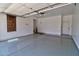 Large garage featuring neutral walls, painted floors, access door, and window with blinds at 4777 S Fulton Ranch Blvd # 1024, Chandler, AZ 85248