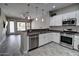 Bright kitchen featuring white cabinetry, stainless steel appliances, and a tiled backsplash at 4777 S Fulton Ranch Blvd # 1024, Chandler, AZ 85248