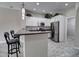 Open kitchen with white cabinets, gray countertops, stainless steel appliances, and bar seating at 4777 S Fulton Ranch Blvd # 1024, Chandler, AZ 85248