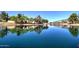 Calm lake view with lush trees and clear blue sky reflected on the water's surface at 4777 S Fulton Ranch Blvd # 1024, Chandler, AZ 85248
