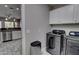 Laundry room featuring stainless steel washer and dryer, white cabinets and tile flooring at 4777 S Fulton Ranch Blvd # 1024, Chandler, AZ 85248