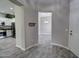 Open-concept living area with wood-look tile flooring leads to a kitchen featuring stainless steel appliances at 4777 S Fulton Ranch Blvd # 1024, Chandler, AZ 85248