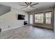 Comfortable living room features a fireplace, mounted TV, and outdoor access at 4777 S Fulton Ranch Blvd # 1024, Chandler, AZ 85248