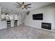 Bright living area showcasing a fireplace, mounted TV, and wood-look tile flooring at 4777 S Fulton Ranch Blvd # 1024, Chandler, AZ 85248