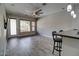 Open floor plan with gray tile flooring, a ceiling fan, and kitchen barstool seating at 4777 S Fulton Ranch Blvd # 1024, Chandler, AZ 85248