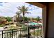 View of the community pool with palm trees and lounge chairs, seen from a balcony at 4777 S Fulton Ranch Blvd # 1024, Chandler, AZ 85248