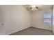 Neutral carpeted room with a window for natural light and a ceiling fan at 6262 E Brown Rd # 65, Mesa, AZ 85205