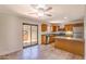 Bright kitchen featuring stainless steel appliances, wood cabinetry, and a sliding door to the patio at 6262 E Brown Rd # 65, Mesa, AZ 85205
