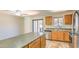 Kitchen with stainless appliances, countertop island, wood cabinets, and a sliding door to the backyard at 6262 E Brown Rd # 65, Mesa, AZ 85205