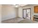Bright kitchen featuring stainless steel appliances, wood cabinetry, and a sliding door to the patio at 6262 E Brown Rd # 65, Mesa, AZ 85205