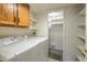 Efficient laundry room equipped with modern washer and dryer, plus ample storage shelving at 6262 E Brown Rd # 65, Mesa, AZ 85205