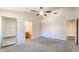 Spacious main bedroom with neutral carpet, a ceiling fan and walk in closet at 6262 E Brown Rd # 65, Mesa, AZ 85205