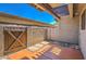 Cozy private patio featuring a concrete floor, a wooden gate, and a view of the blue sky at 6262 E Brown Rd # 65, Mesa, AZ 85205