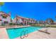 Community pool with turquoise water and lounge chairs alongside well-maintained residential buildings at 6262 E Brown Rd # 65, Mesa, AZ 85205